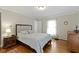Comfortable bedroom with hardwood floors and a cozy bed at 7481 Holliday E Dr, Indianapolis, IN 46260