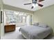 Comfortable bedroom with large windows, a desk, and a cozy bed at 7481 Holliday E Dr, Indianapolis, IN 46260