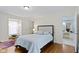 Bedroom featuring hardwood floors and an attached bathroom at 7481 Holliday E Dr, Indianapolis, IN 46260