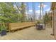 Spacious wooden deck with built-in bench seating and a wrought iron table and chairs at 7481 Holliday E Dr, Indianapolis, IN 46260
