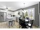 Inviting dining area with natural light, black chairs and an adjacent kitchen at 7481 Holliday E Dr, Indianapolis, IN 46260