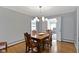 Classic dining room with wood table, chairs, hardwood flooring, and stylish chandelier at 7481 Holliday E Dr, Indianapolis, IN 46260