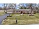 Beautiful ranch-style home boasting a lovely front yard and inviting curb appeal at 7481 Holliday E Dr, Indianapolis, IN 46260