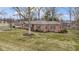 Well-maintained brick ranch with a green lawn and driveway at 7481 Holliday E Dr, Indianapolis, IN 46260
