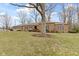 Sprawling ranch home with mature trees, brick facade and attached garage at 7481 Holliday E Dr, Indianapolis, IN 46260