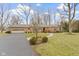 Charming brick home with attached garage, manicured lawn, and inviting walkway at 7481 Holliday E Dr, Indianapolis, IN 46260
