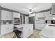 Well-lit kitchen featuring white cabinets, stainless steel appliances, an island and stylish breakfast bar at 7481 Holliday E Dr, Indianapolis, IN 46260
