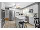 Bright kitchen with stainless steel appliances, white cabinetry, an island and a breakfast bar at 7481 Holliday E Dr, Indianapolis, IN 46260