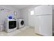 Well-equipped laundry room with washer, dryer, and white refrigerator at 7481 Holliday E Dr, Indianapolis, IN 46260