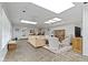 Bright living room featuring stone floors, skylights, and a large sectional sofa at 7481 Holliday E Dr, Indianapolis, IN 46260