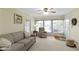 Bright living room with sofa, recliner, natural light, and access to the front door at 7481 Holliday E Dr, Indianapolis, IN 46260