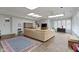 Bright living room featuring stone floors, skylights, and a large sectional sofa at 7481 Holliday E Dr, Indianapolis, IN 46260