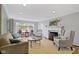 Inviting living room with fireplace, large window and comfortable seating arrangement at 7481 Holliday E Dr, Indianapolis, IN 46260