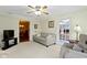 Cozy living room featuring a sofa, recliner, and doorways to the dining room at 7481 Holliday E Dr, Indianapolis, IN 46260