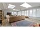 Sunroom with large windows, tile floors, a large sofa, and a vibrant rug at 7481 Holliday E Dr, Indianapolis, IN 46260