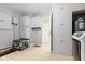 Organized utility room with storage cabinets, washer, dryer and tiled flooring at 7481 Holliday E Dr, Indianapolis, IN 46260