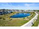Aerial view of the community pond surrounded by manicured lawns and homes at 753 Madelyn Dr, Carmel, IN 46032