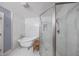 Bright bathroom featuring a clawfoot tub and a glass-enclosed shower, complemented by elegant marble tiling at 839 N Park Trail Dr, Carmel, IN 46032
