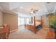 Comfortable bedroom features a four-poster bed, tray ceiling, ceiling fan, and bay windows at 839 N Park Trail Dr, Carmel, IN 46032