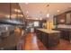 Kitchen with dark cabinets, stainless appliances, an island and hardwood floors at 839 N Park Trail Dr, Carmel, IN 46032