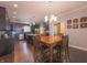 Open concept kitchen with dining area features dark cabinets, stainless steel appliances, and hardwood floors at 839 N Park Trail Dr, Carmel, IN 46032