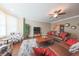 Inviting living room features hardwood floors, neutral walls, brown leather sofas and a ceiling fan at 839 N Park Trail Dr, Carmel, IN 46032