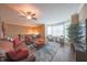 Cozy living room with hardwood floors, leather sofa, ceiling fan, and plenty of natural light at 839 N Park Trail Dr, Carmel, IN 46032
