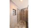 Luxurious tiled shower with a built-in niche, a rainfall showerhead, and mosaic accents for a spa-like experience at 839 N Park Trail Dr, Carmel, IN 46032