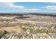 An aerial view of a neighborhood with a pond, barn, and highway in the distance at 9132 Log Run N Dr, Indianapolis, IN 46234