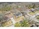 An aerial view of a single Gathering home displaying its landscaping, driveway, and street at 9132 Log Run N Dr, Indianapolis, IN 46234