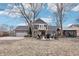 Expansive back exterior featuring a spacious patio with a firepit, grill, shed, and lush landscaping at 9132 Log Run N Dr, Indianapolis, IN 46234