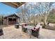 Backyard with a bar, seating, a table and a fire pit on a stone patio with a shed at 9132 Log Run N Dr, Indianapolis, IN 46234
