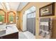 Bathroom with a vanity, a mirror, a painting and a shower tub combo with a white shower curtain at 9132 Log Run N Dr, Indianapolis, IN 46234