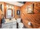 Unique rustic bathroom featuring wood paneling, a modern vanity, and vintage accents at 9132 Log Run N Dr, Indianapolis, IN 46234