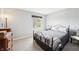 Cozy bedroom featuring a metal frame bed, light-colored walls, and a bright window view at 9132 Log Run N Dr, Indianapolis, IN 46234