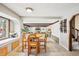 Bright breakfast nook with a cozy window seat, connecting to the living room and staircase at 9132 Log Run N Dr, Indianapolis, IN 46234