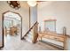 Inviting foyer showcasing a wooden console table and stairs leading to the upper level at 9132 Log Run N Dr, Indianapolis, IN 46234