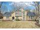 Inviting front exterior with a stone facade, complemented by lush landscaping and a well-manicured lawn at 9132 Log Run N Dr, Indianapolis, IN 46234