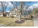 Attractive home exterior featuring a stone facade, and well-maintained landscaping at 9132 Log Run N Dr, Indianapolis, IN 46234