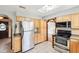 Bright kitchen with stainless steel refrigerator and ample cabinet space, adjacent to the dining area at 9132 Log Run N Dr, Indianapolis, IN 46234