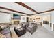 Cozy living room with a stone fireplace, beamed ceilings, and comfortable seating at 9132 Log Run N Dr, Indianapolis, IN 46234