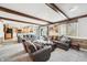 Spacious living room featuring neutral decor, exposed beams, and access to kitchen and backyard at 9132 Log Run N Dr, Indianapolis, IN 46234