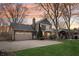 A spacious backyard featuring a two-car garage, patio, and outdoor seating area at 9132 Log Run N Dr, Indianapolis, IN 46234
