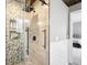 Modern tiled shower enclosure with glass door, rainfall shower head, and built-in storage at 9132 Log Run N Dr, Indianapolis, IN 46234