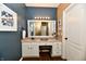 Bathroom boasts double sink vanity with bright mirror and wood look flooring at 9640 Clover Leaf Ln, Fishers, IN 46038