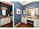 Bathroom features a double vanity, granite counters, and wood look flooring at 9640 Clover Leaf Ln, Fishers, IN 46038
