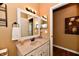 Traditional bathroom with a framed mirror, lighting fixture, and light-colored countertop and cabinets at 9640 Clover Leaf Ln, Fishers, IN 46038