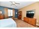 Bedroom features a wooden desk and dresser set, complemented by soft lighting at 9640 Clover Leaf Ln, Fishers, IN 46038