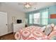 Bedroom features ceiling fan and view of a large window with natural light at 9640 Clover Leaf Ln, Fishers, IN 46038