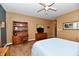 A tidy bedroom featuring wooden shelving and a large flat screen television at 9640 Clover Leaf Ln, Fishers, IN 46038